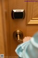 A person is opening a door with a smart lock.