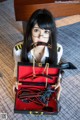 A woman holding a red box with a pair of handcuffs in it.