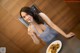 A woman sitting at a table with a plate of food.