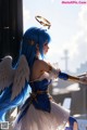 Anime girl with blue hair and angel wings holding a sword.