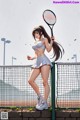 A woman holding a tennis racket on a tennis court.